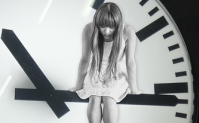 girl perched on clock hand