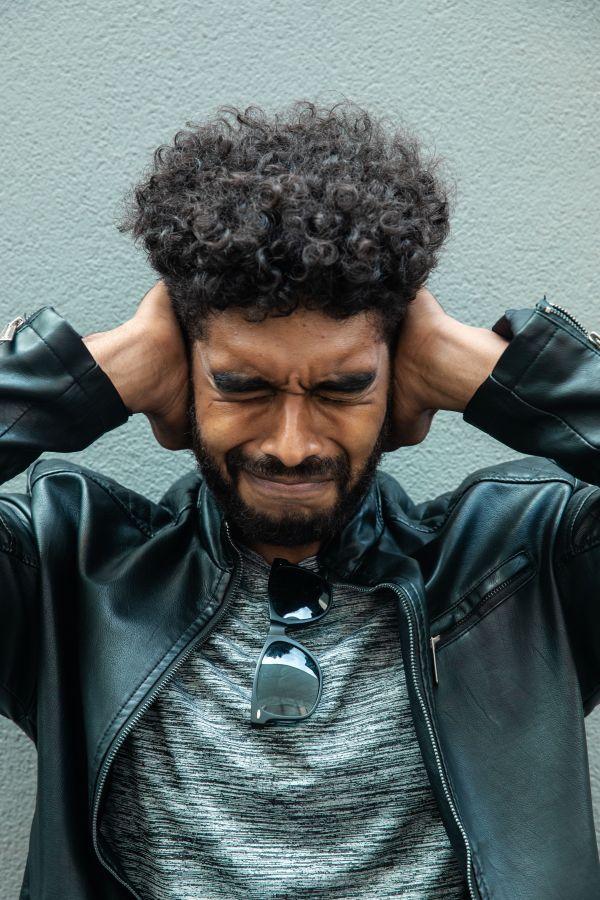 man holding his ears