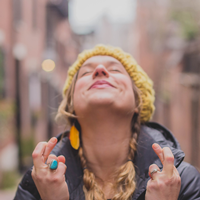 hopeful woman with fingers crossed