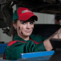 female mechanic under car