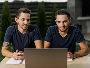 twin brothers searching laptop