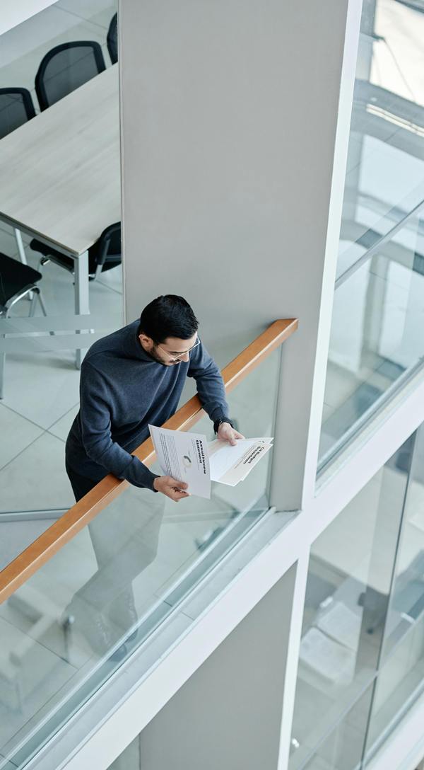 sillouettes of two men and a woman in front of a clock