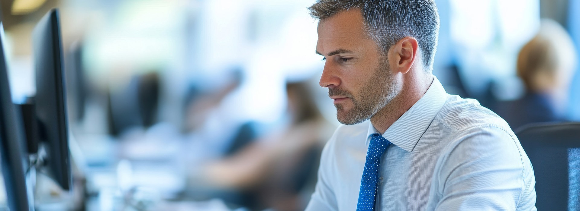 business man at computer with blue tie
