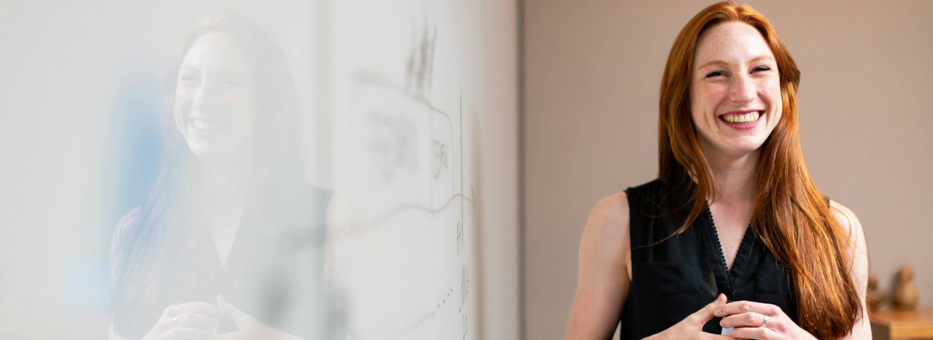 woman ready to present at a white board